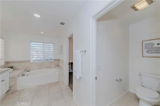 a bathroom with a bathtub and toilet