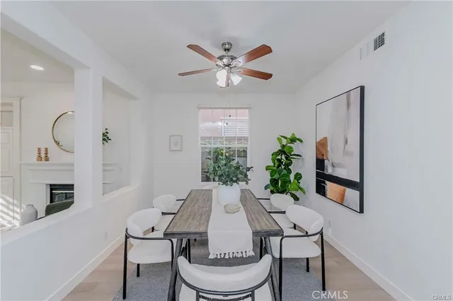 a dining room with furniture a fireplace and a chandelier