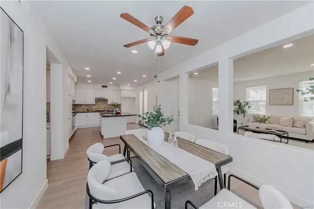 a living room with furniture kitchen view and a table