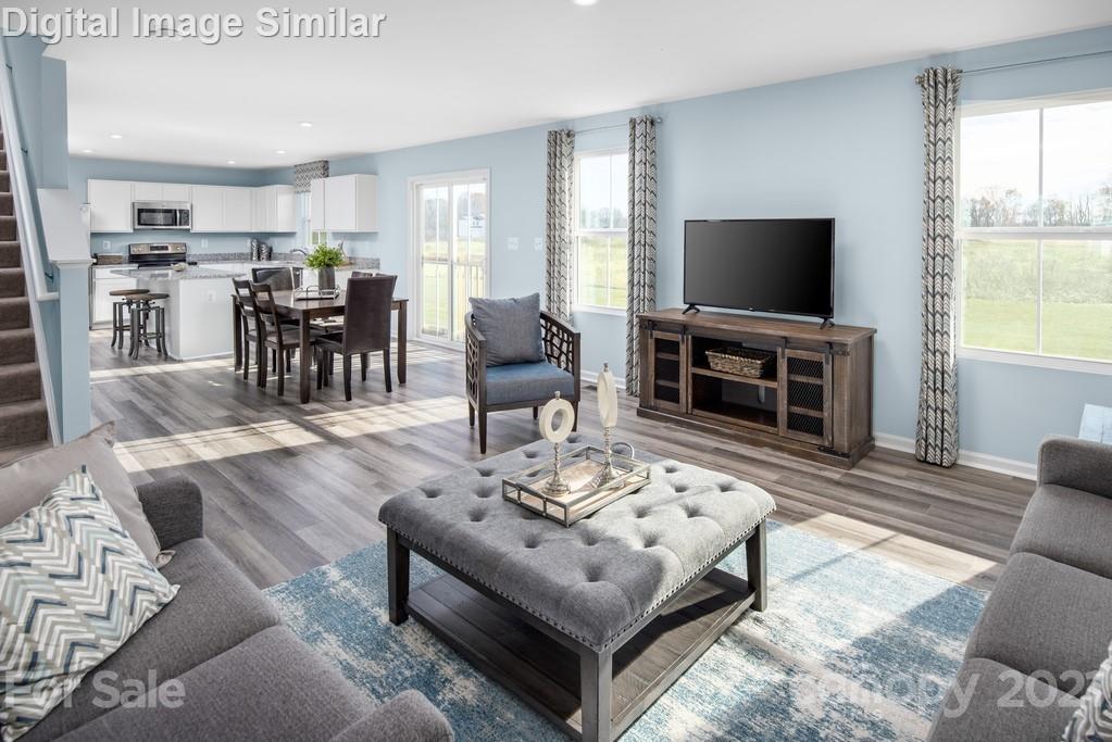 5130 Tinker Field Road, Unit 2021 Charlotte, NC 28215 - Photo 3 of 10 a living room with furniture and a flat screen tv