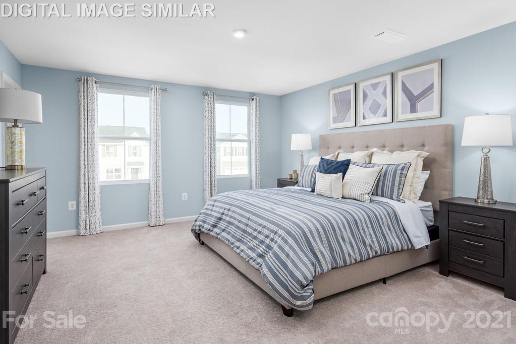 5130 Tinker Field Road, Unit 2021 Charlotte, NC 28215 - Photo 5 of 10 a spacious bedroom with a bed and a window