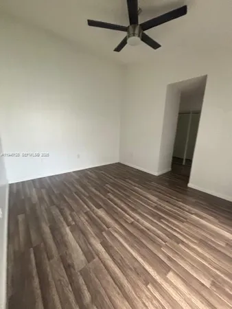 a view of a room with wooden floor