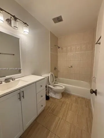 a bathroom with a double vanity sink toilet and shower