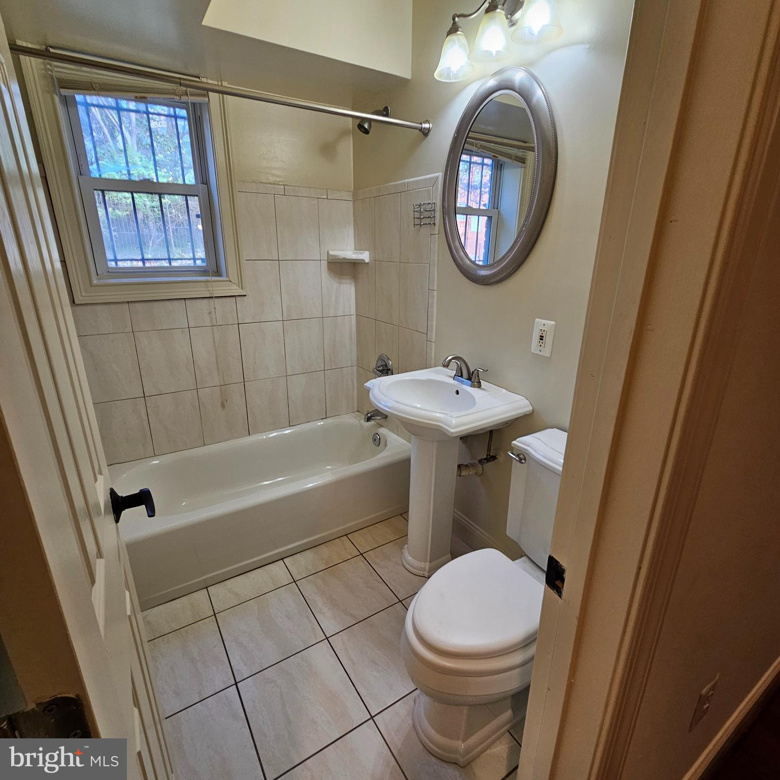 4800 C Street Southeast, Unit 102 Washington, DC 20019 - Photo 13 of 14 a bathroom with a toilet a sink and a bathtub
