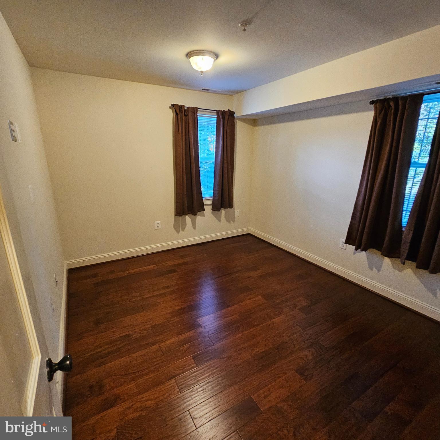 4800 C Street Southeast, Unit 102 Washington, DC 20019 - Photo 14 of 14 an empty room with wooden floor and windows