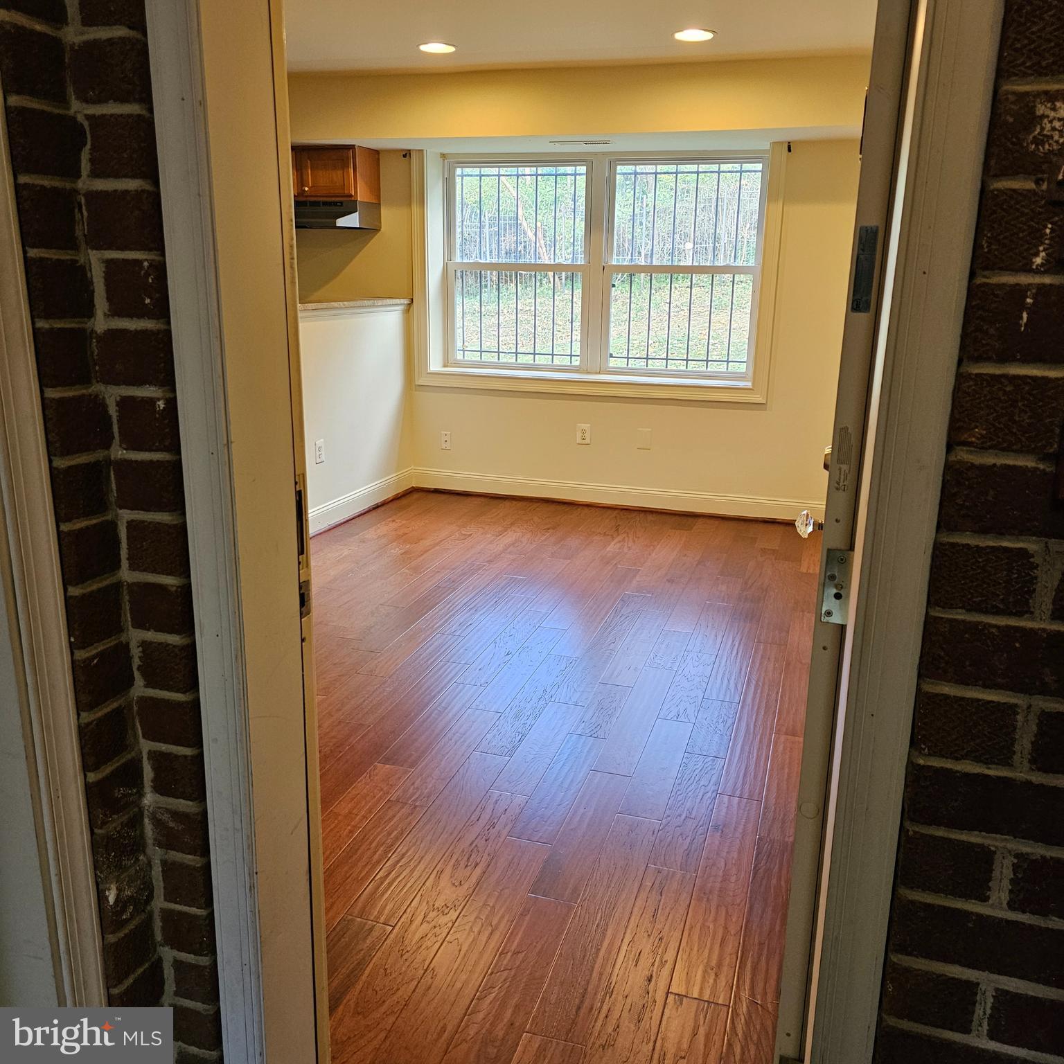 4800 C Street Southeast, Unit 102 Washington, DC 20019 - Photo 4 of 14 a view of an empty room with wooden floor and windows