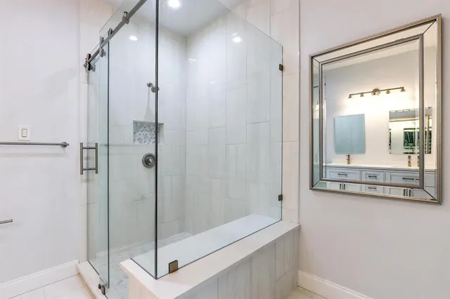 a bathroom with a shower and a sink
