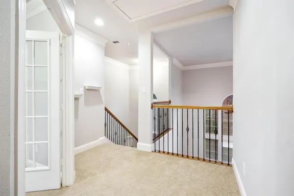 a view of a hallway with wooden floor and entryway