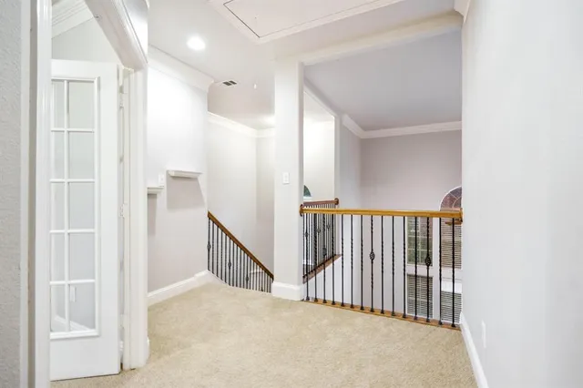 a view of a hallway with wooden floor and entryway