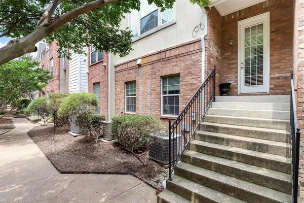 a view of a house with plants and windows