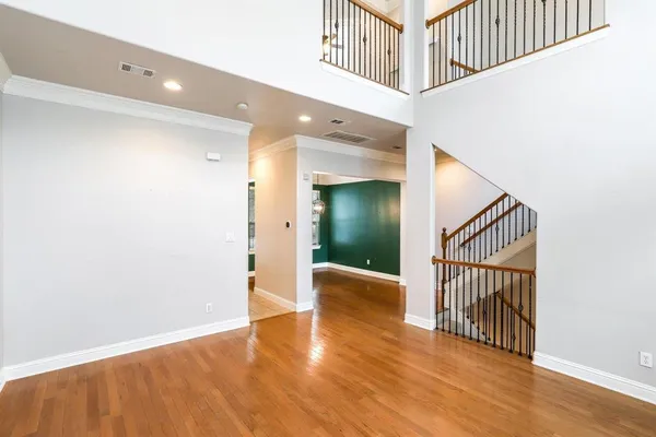 a view of a hallway with wooden floor
