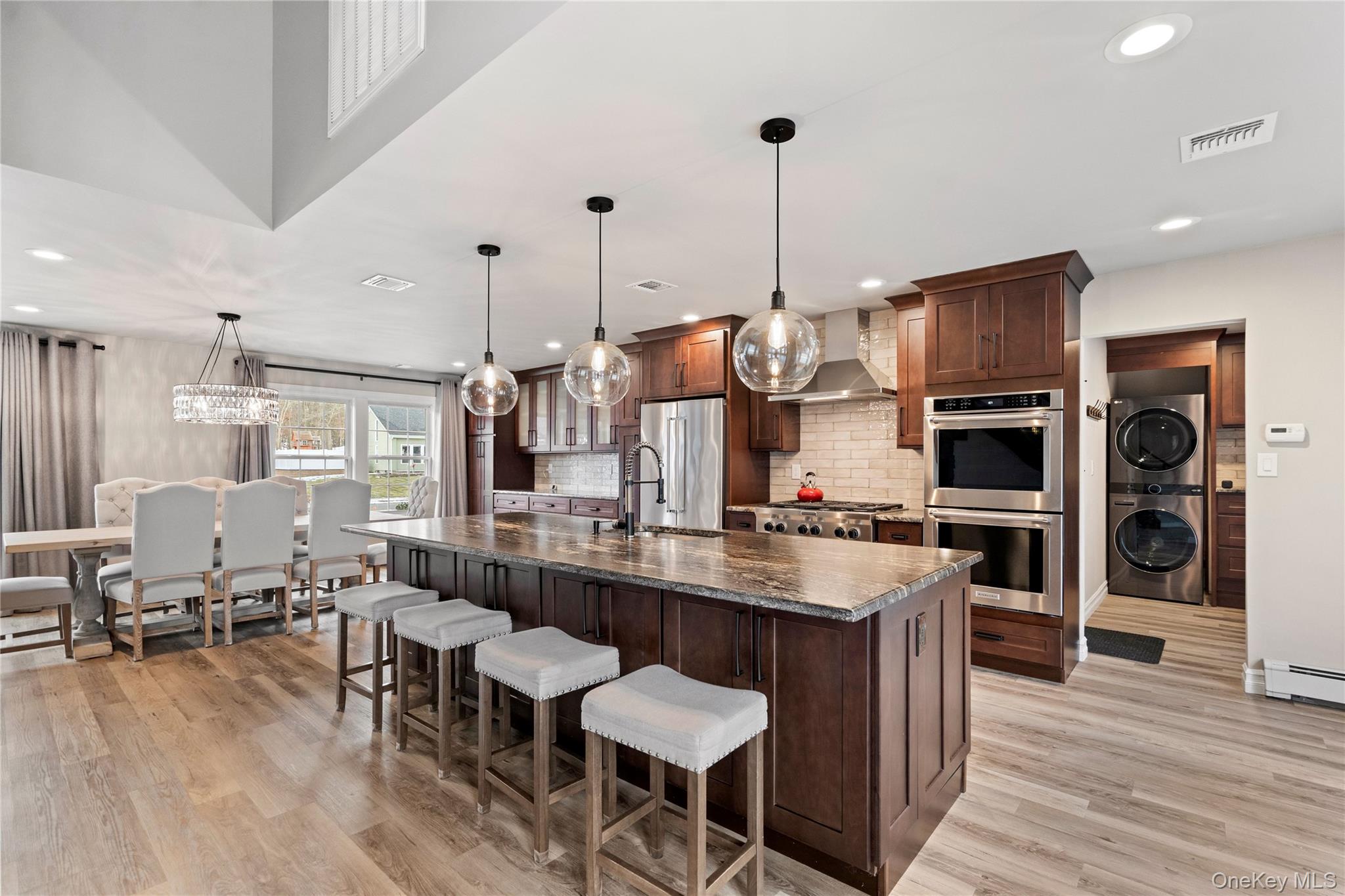 58 Timber Ridge Drive Commack, NY 11725 - Photo 13 of 34 Kitchen featuring appliances with stainless steel finishes, recessed lighting, a breakfast bar, decorative light fixtures, and an island with sink