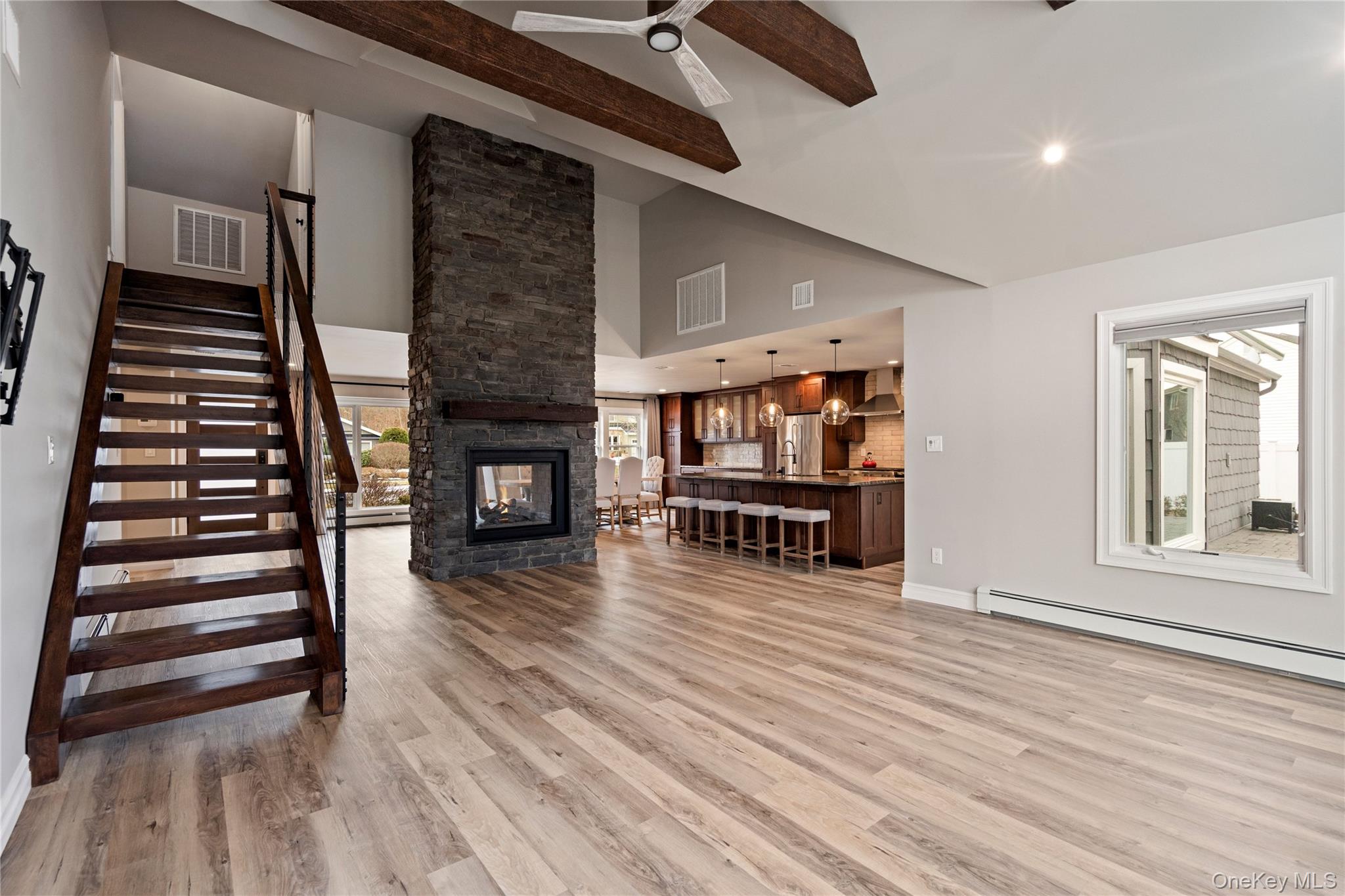 58 Timber Ridge Drive Commack, NY 11725 - Photo 17 of 34 Unfurnished living room with a fireplace, light wood finished floors, a baseboard heating unit, ceiling fan, and recessed lighting