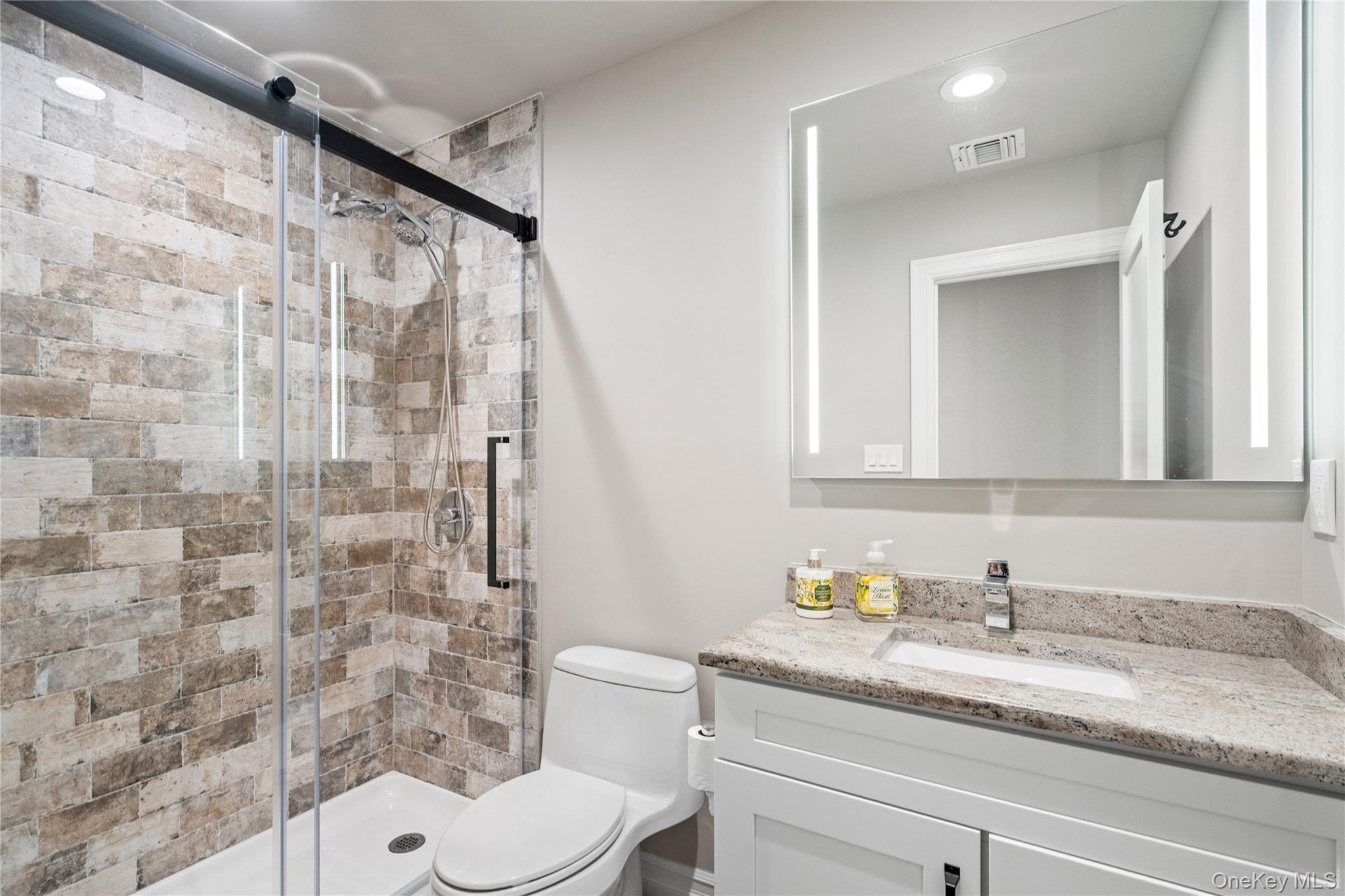 58 Timber Ridge Drive Commack, NY 11725 - Photo 25 of 34 Bathroom with vanity, a stall shower, and recessed lighting