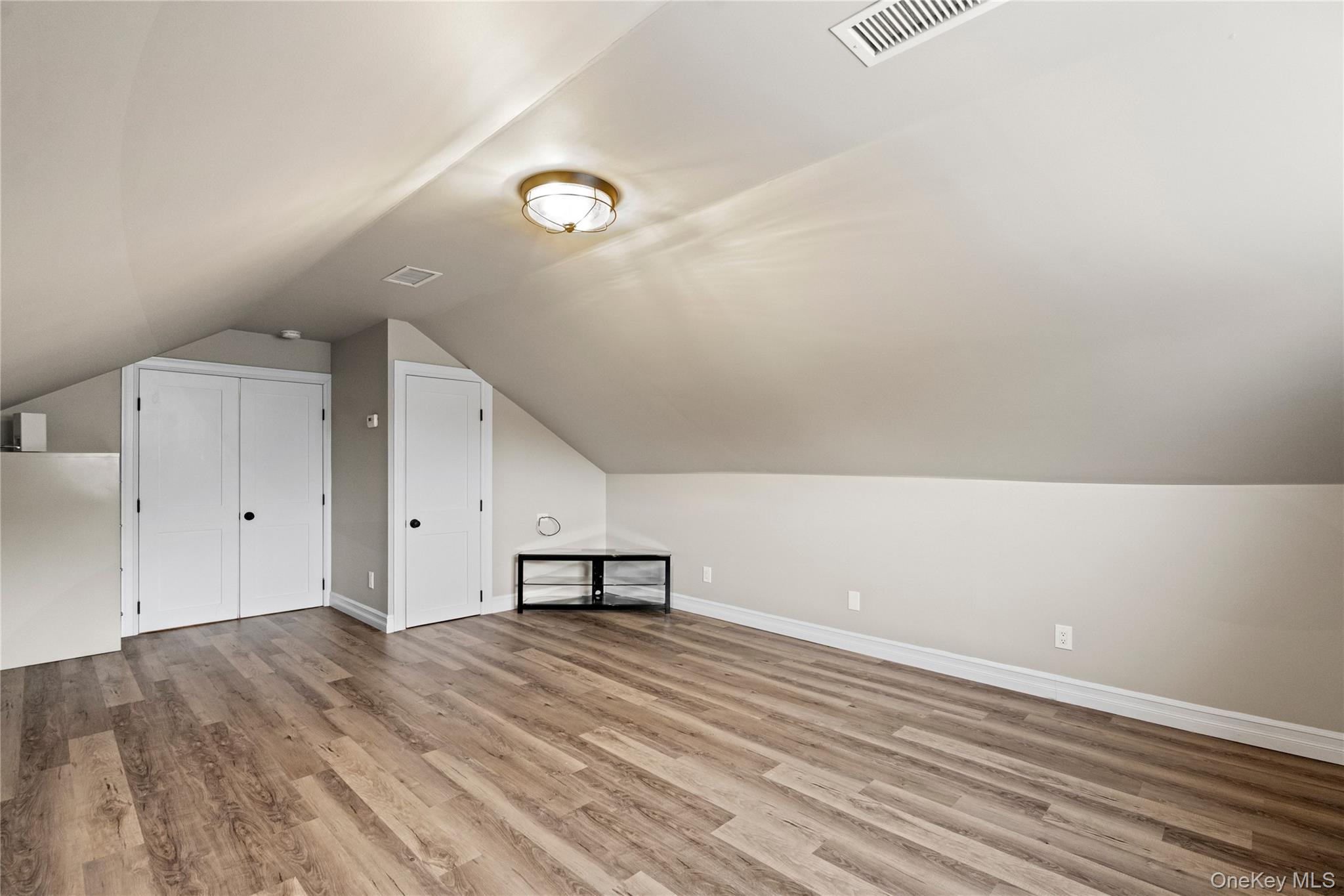 58 Timber Ridge Drive Commack, NY 11725 - Photo 28 of 34 Bonus room with lofted ceiling and light wood finished floors