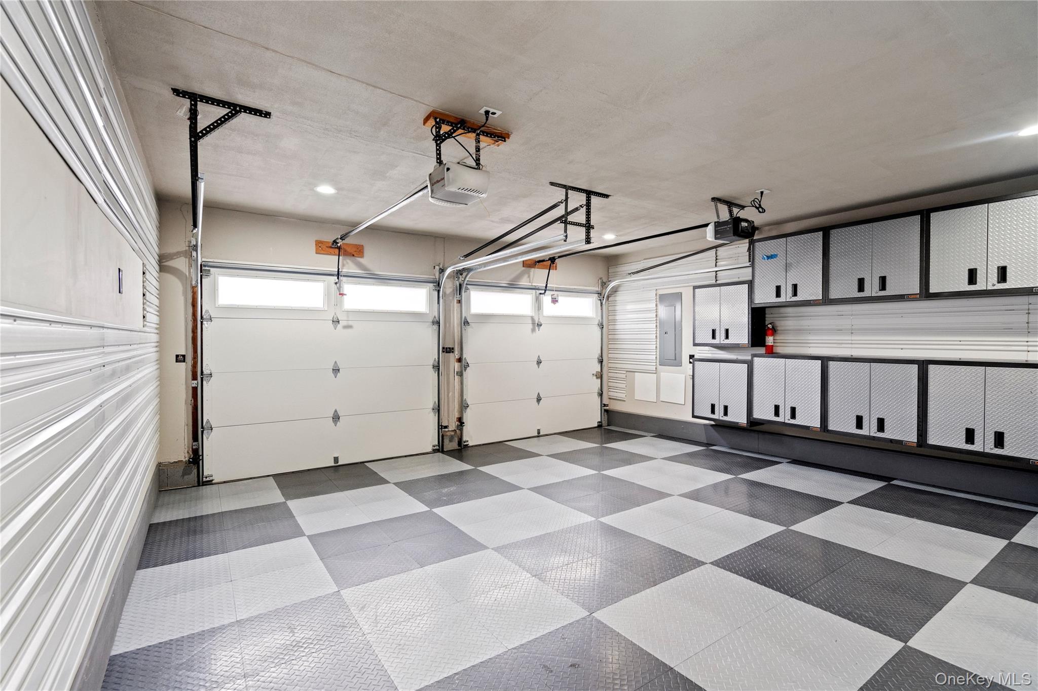 58 Timber Ridge Drive Commack, NY 11725 - Photo 30 of 34 Garage featuring a garage door opener and electric panel