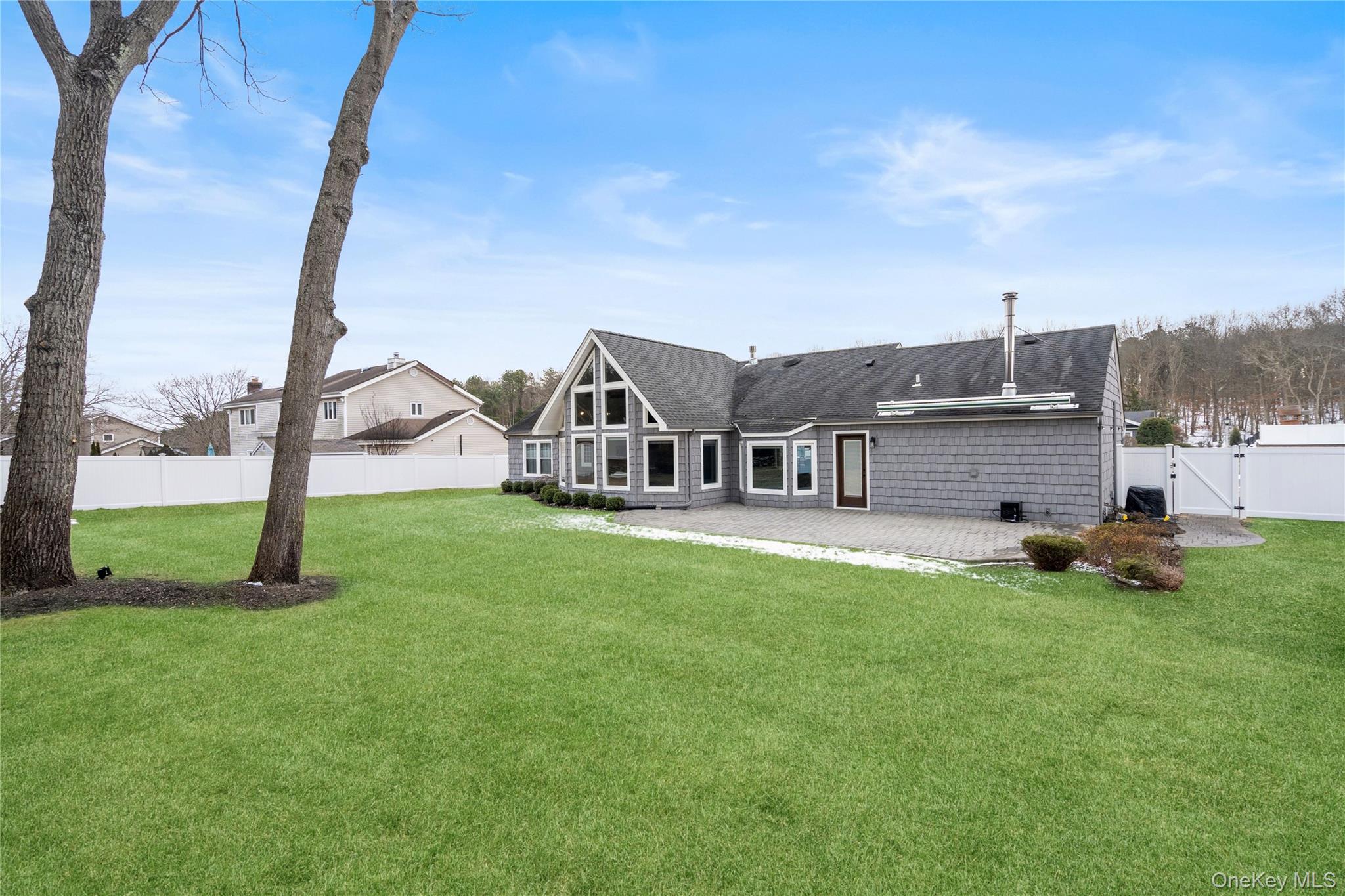 58 Timber Ridge Drive Commack, NY 11725 - Photo 32 of 34 Back of property with a patio, a gate, a fenced backyard, and roof with shingles