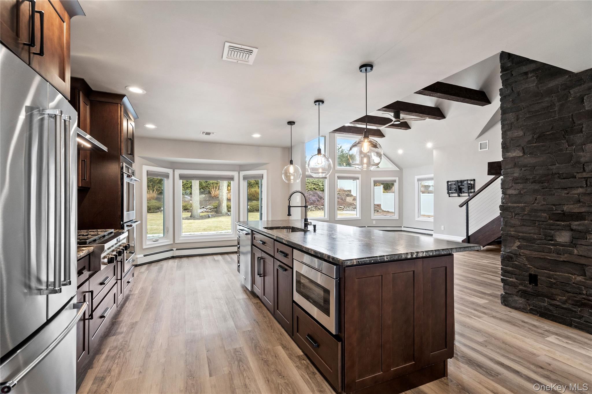 58 Timber Ridge Drive Commack, NY 11725 - Photo 7 of 34 Kitchen featuring dark brown cabinets, appliances with stainless steel finishes, light wood finished floors, and recessed lighting