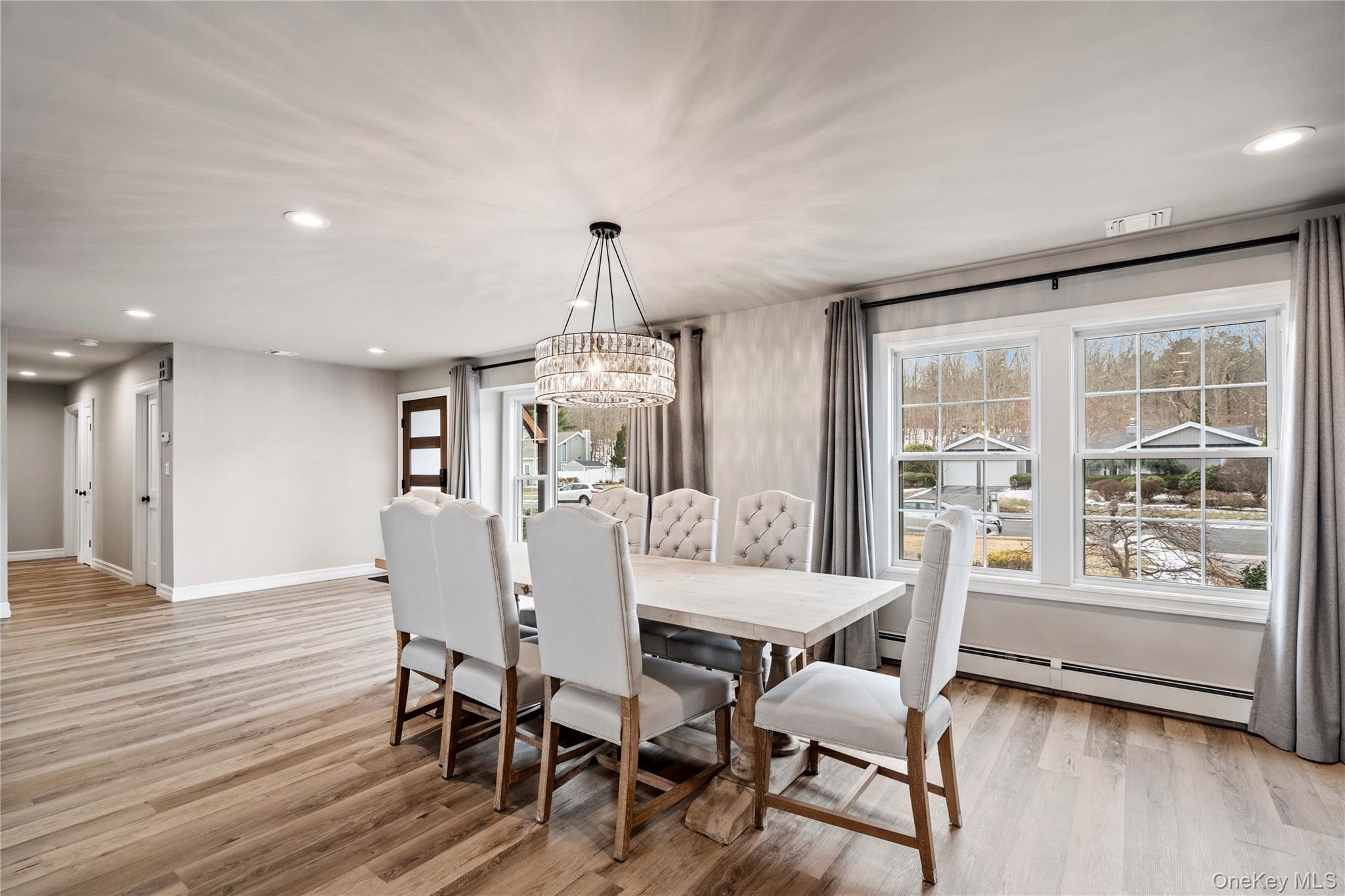 58 Timber Ridge Drive Commack, NY 11725 - Photo 8 of 34 Dining area with recessed lighting, light wood-style flooring, baseboard heating, and a chandelier