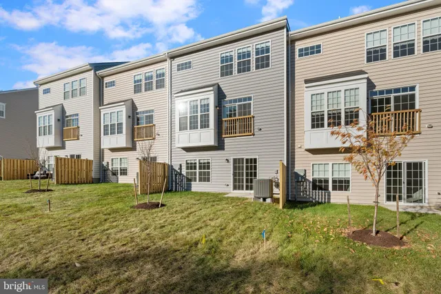 a view of a house with backyard and porch