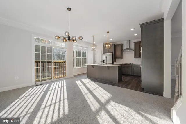 a view of a kitchen with kitchen island and stainless steel appliances