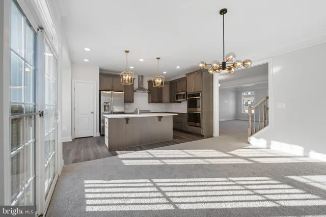 a view of kitchen with sink and refrigerator
