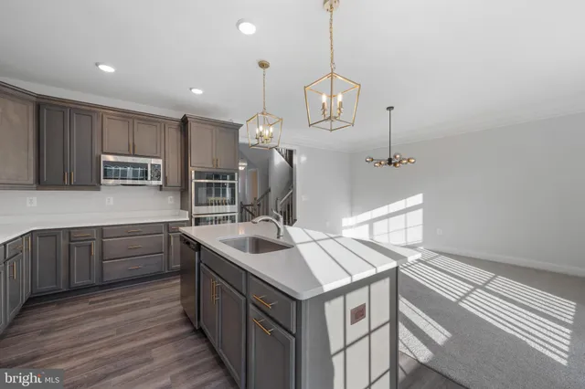 a kitchen with a sink stove and microwave