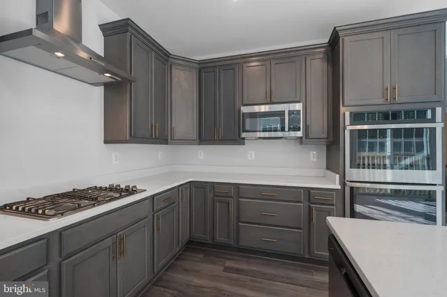 a kitchen with sink cabinets and stainless steel appliances