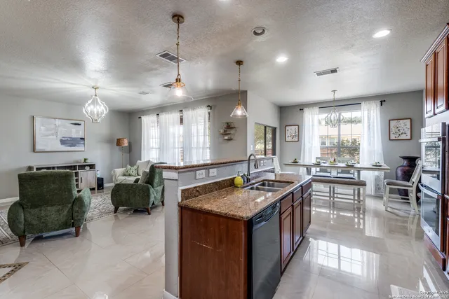 a kitchen with counter top space and living room