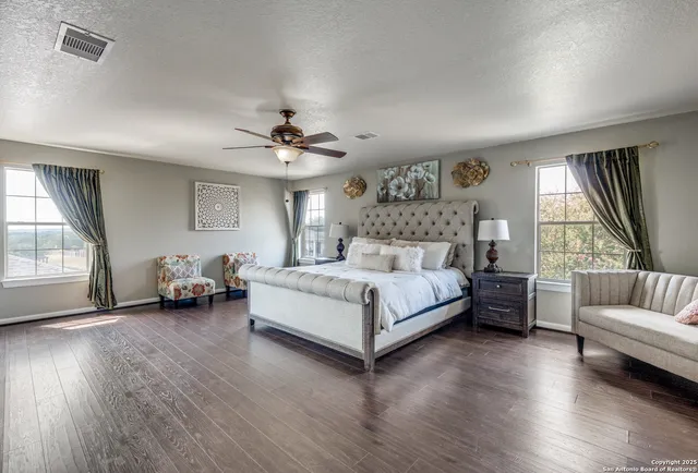 a bedroom with a bed couches and a couch