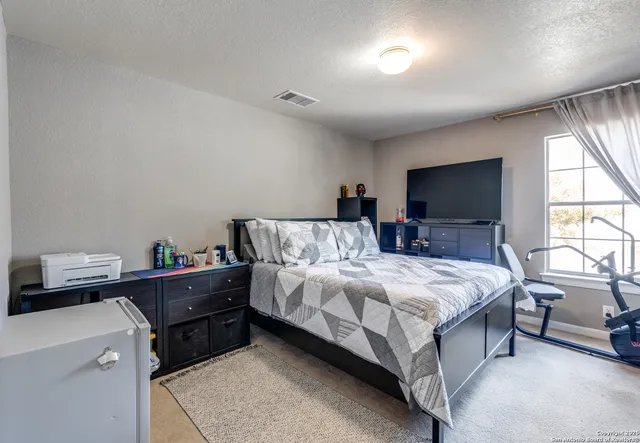 a bed room with a bed and a tv