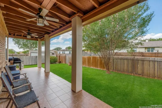 a view of a house with a yard and sitting area