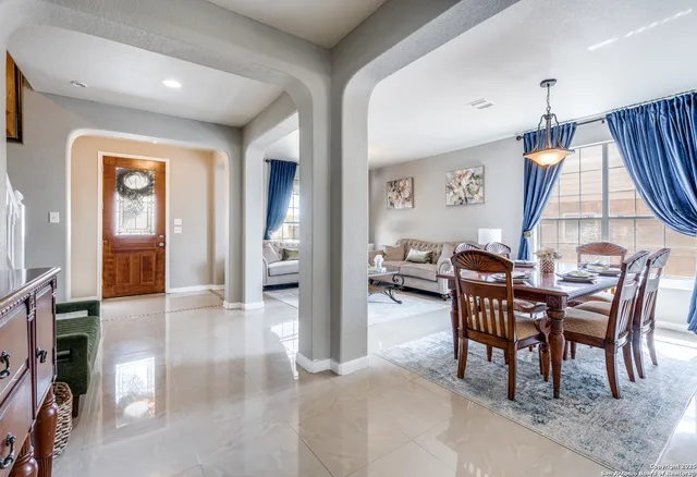 a dining room with furniture and window