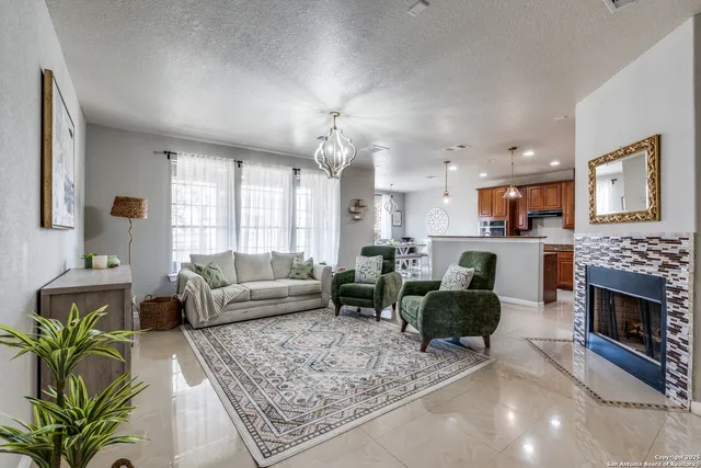 a living room with furniture a fireplace and a flat screen tv