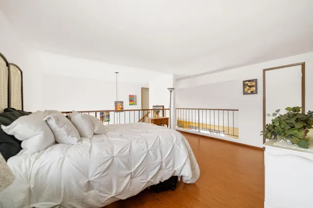 a bed sitting in a bedroom next to a balcony