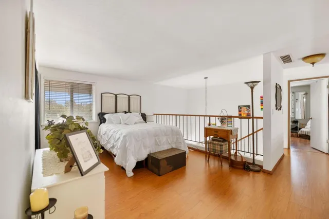 a spacious bedroom with a bed and a table