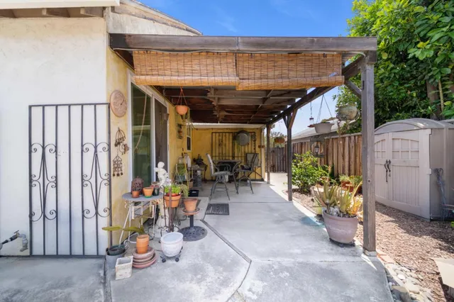 a view of a patio with table and chairs and potted plants