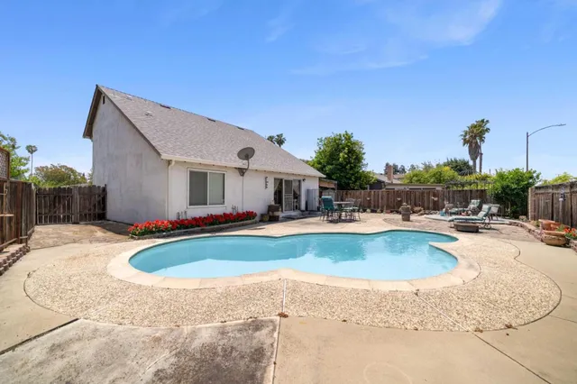 a view of a house with swimming pool and sitting area