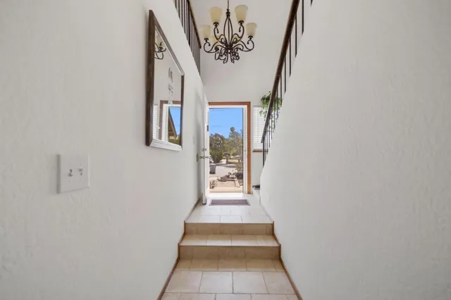 a view of a hallway with wooden floor and windows