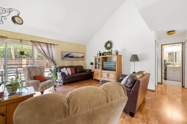 a bedroom with furniture and a large window