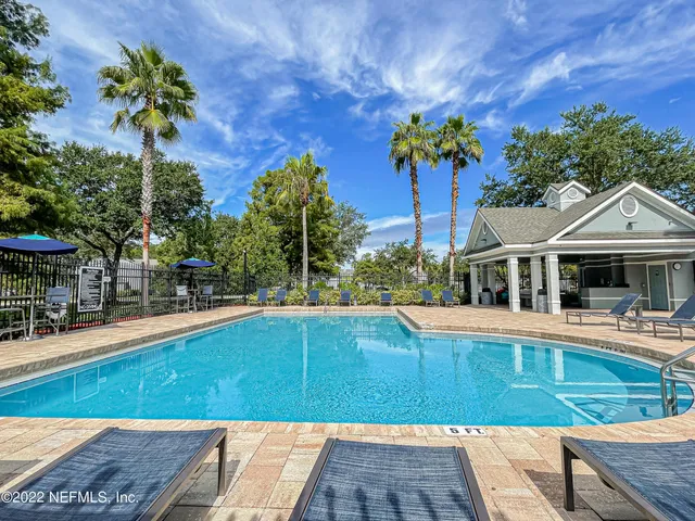 a view of a swimming pool with a lounge chair