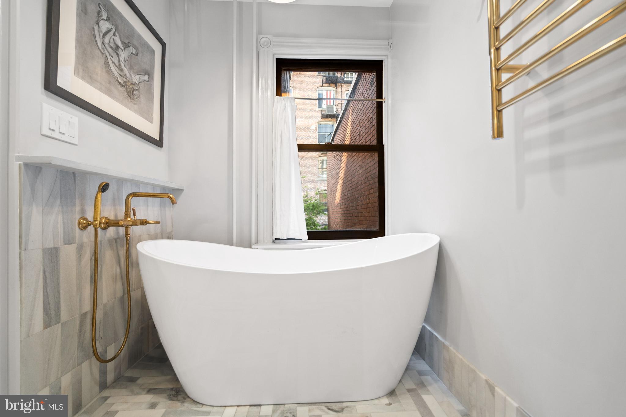 2026 15th Street Northwest Washington, DC 20009 - Photo 25 of 47 a white bath tub sitting in a bathroom