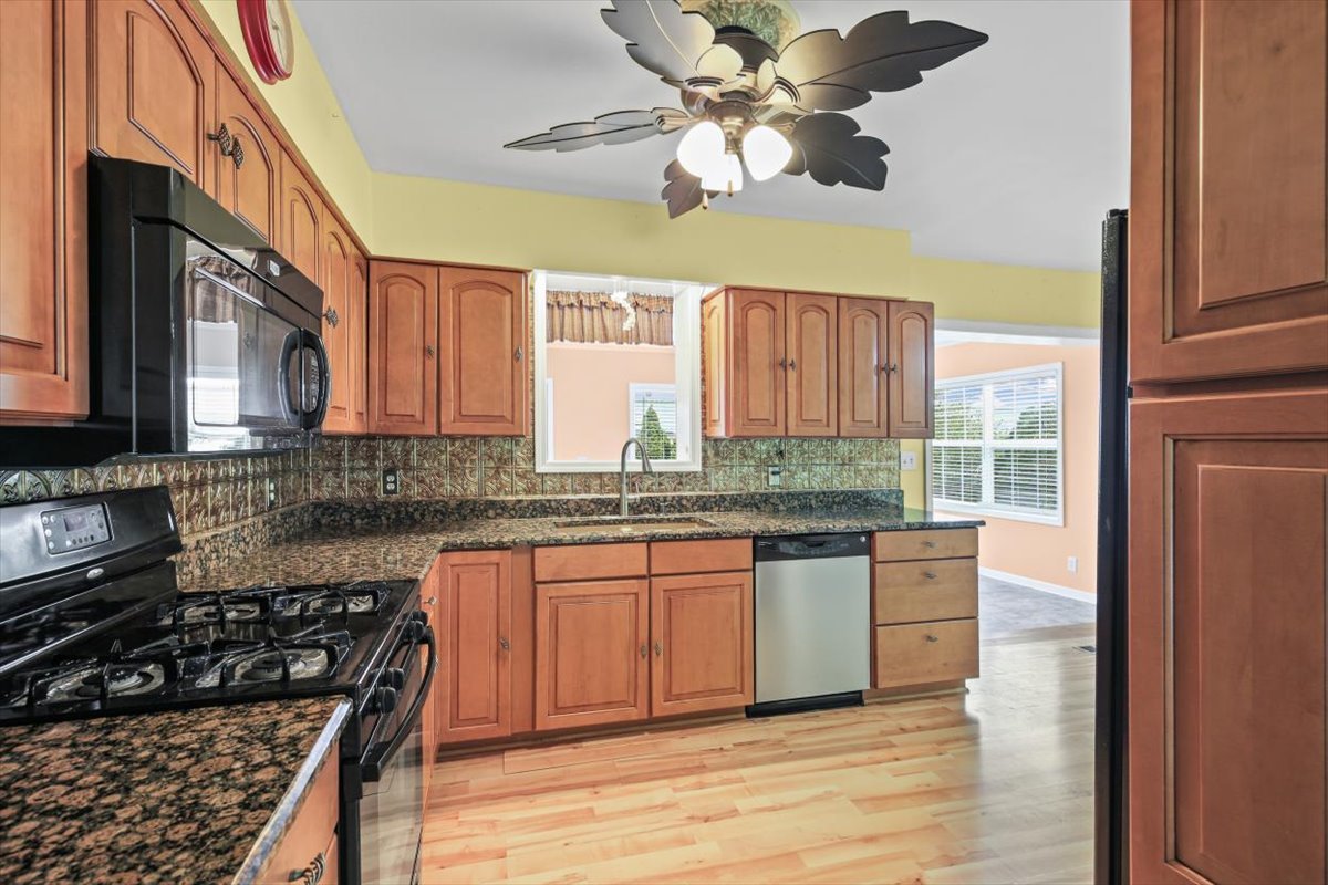 1513 Gates Drive Rantoul, IL 61866 - Photo 11 of 37 a kitchen with stainless steel appliances granite countertop a stove a sink and a microwave