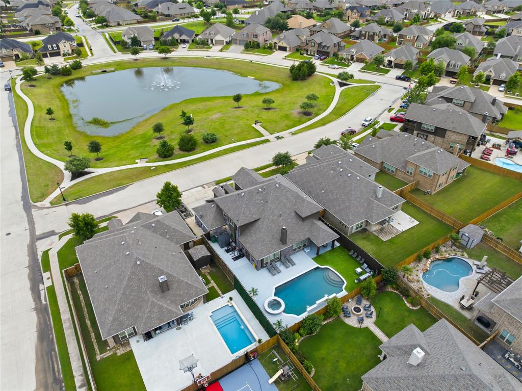 1802 Roundtree Road Forney, TX 75126 - Photo 4 of 39 an aerial view of a swimming pool with outdoor seating