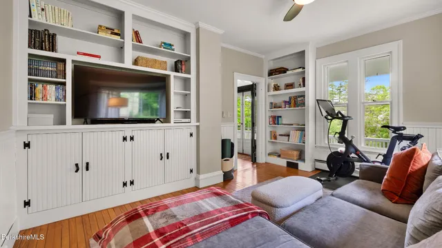 a bedroom with furniture and a flat screen tv
