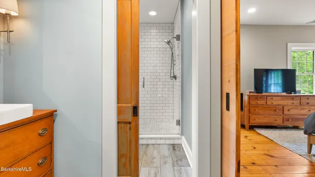 a en suite bathroom with a granite countertop sink