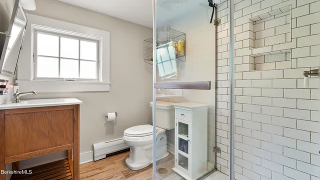 a bathroom with a sink toilet and shower