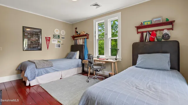 a bedroom with furniture and a large window