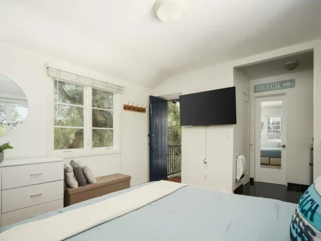 a bedroom with a bed and a flat screen tv