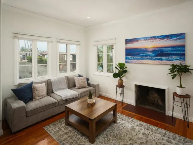 a living room with furniture a fireplace and windows